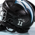 Black hockey helmet with 'Smith 11' branding on a light blue background