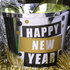 Decorative bucket with 'Happy New Year' text on a festive background
