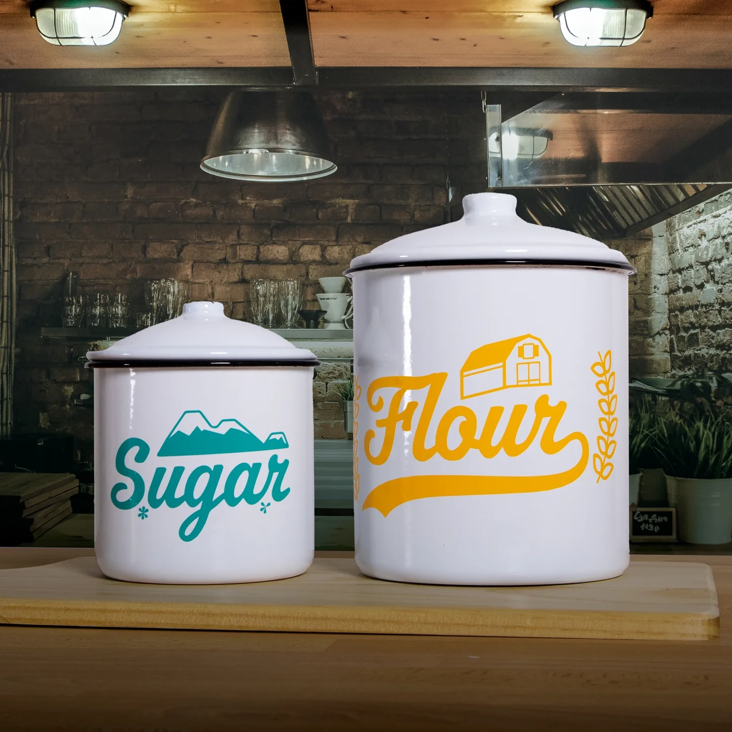 Two white canisters labeled 'Sugar' and 'Flour' on a wooden surface with a rustic kitchen background.