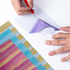 Person applying colorful vinyl to a surface with a tool