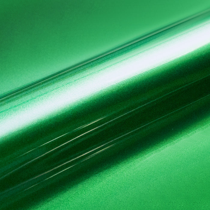 Close-up of green metallic vinyl wrap with a reflective surface.