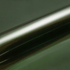 Metallic dark green vinyl wrap roll on a green background