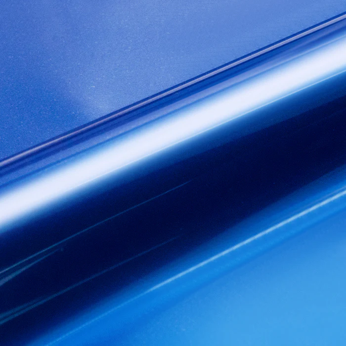 Roll of blue vinyl wrap on a blue background