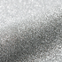 Close-up of silver glitter on a light gray background