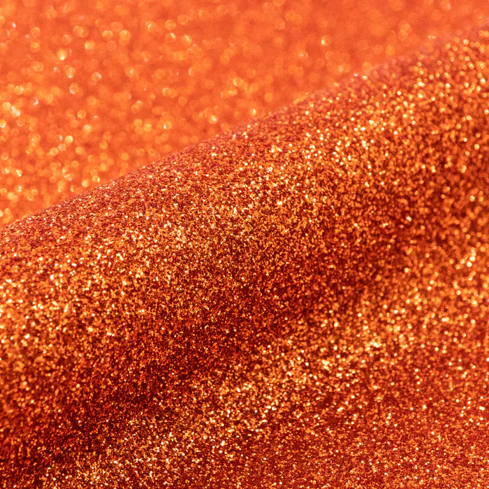 Close-up of orange glittery vinyl texture