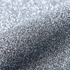 Close-up of silver glitter on a textured surface