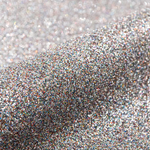 Close-up of silver glitter on a light gray background