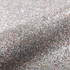 Close-up of silver glitter on a light gray background