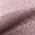 Close-up of glittery vinyl with a pinkish-purple hue