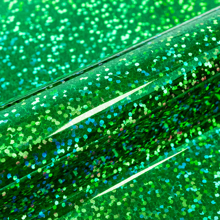 Close-up of green glittery vinyl with a reflective surface