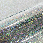 Close-up of a glittery vinyl with multicolored dots on a textured surface.