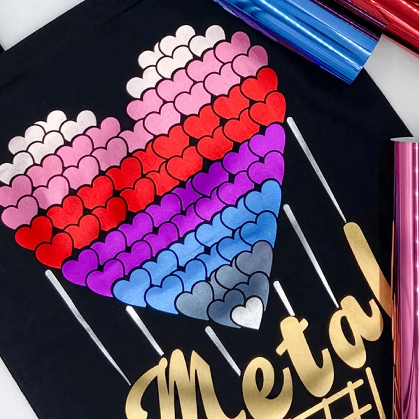 Colorful heart-shaped confetti on a black surface with tools and metallic text.