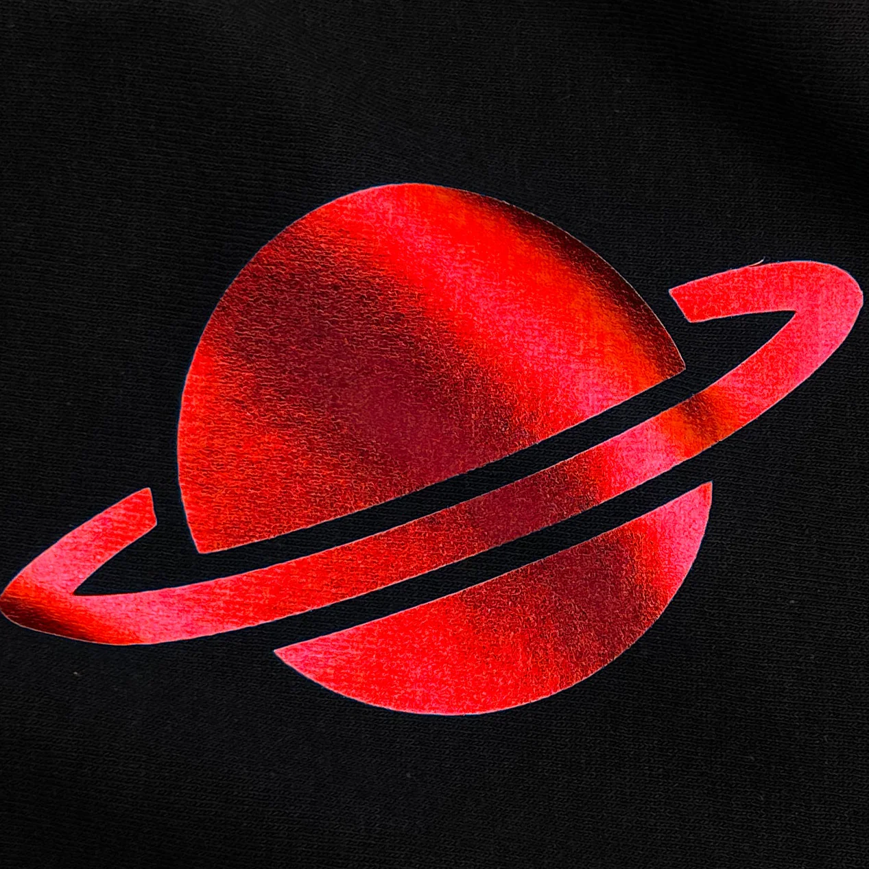 Red planet with rings on a black background