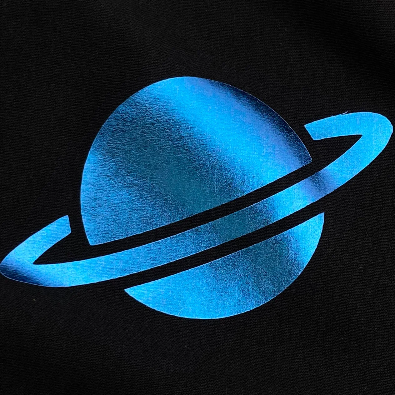 Blue planet with rings on a black background