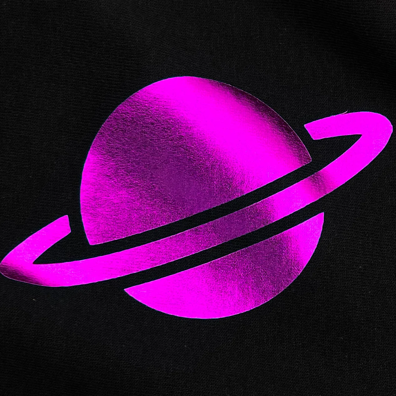 Purple planet with a ring on a black background