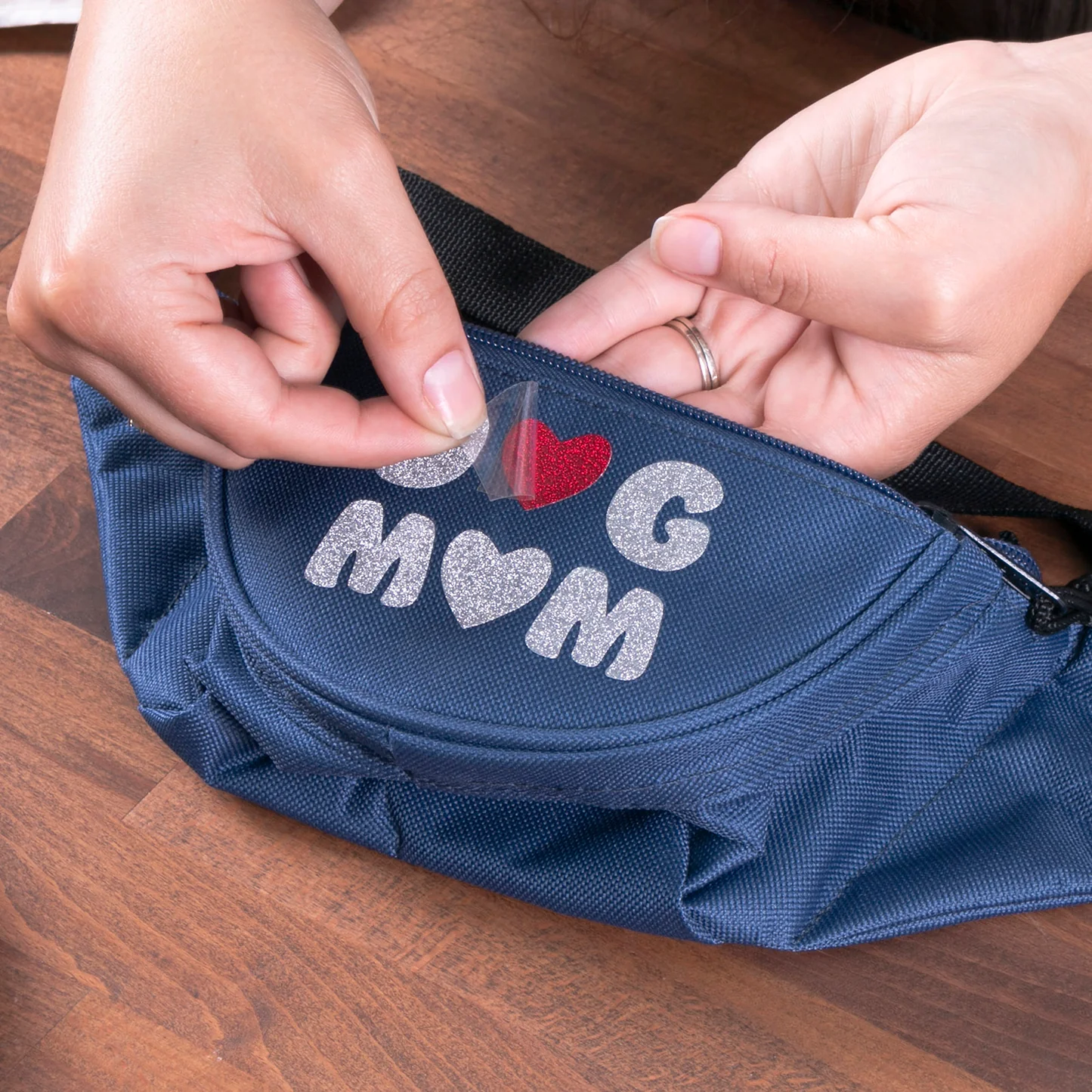 Blue bag with 'Dog Mom' text on a wooden surface