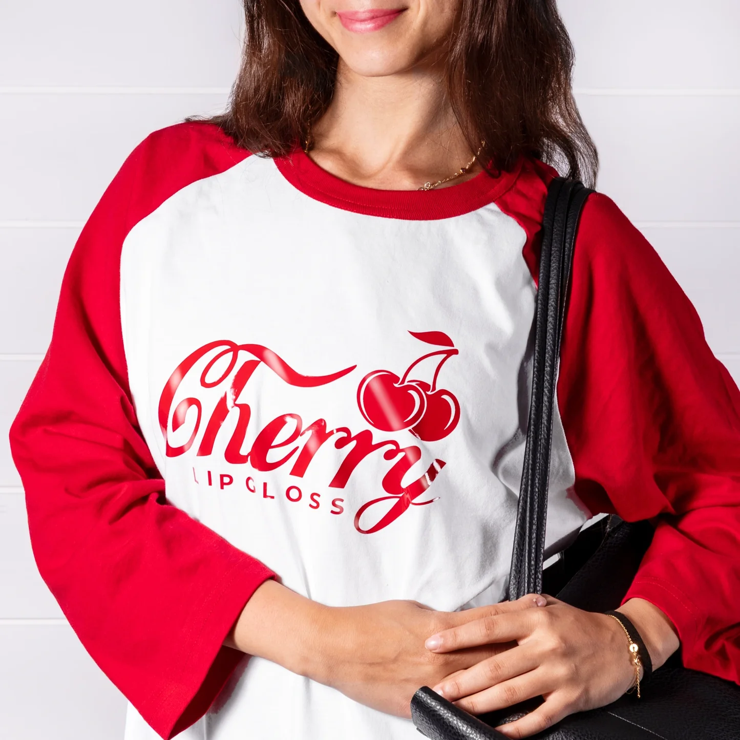 Person wearing a red and white shirt with 'Cherry Lip Gloss' design.
