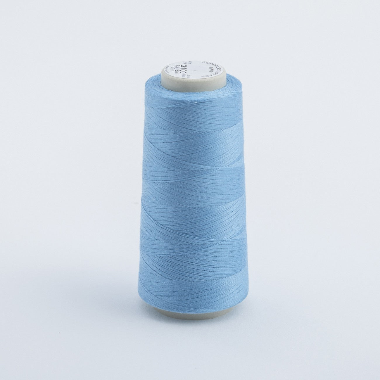 Light blue spool of thread on a light gray background