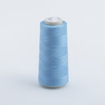 Light blue spool of thread on a light gray background