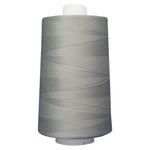 Large spool of gray thread on a white background
