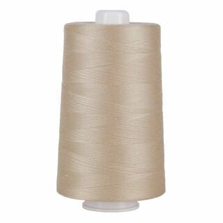 Spool of beige thread on a white background