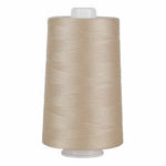 Spool of beige thread on a white background