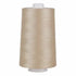 Spool of beige thread on a white background