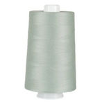 Spool of light gray thread on a white background