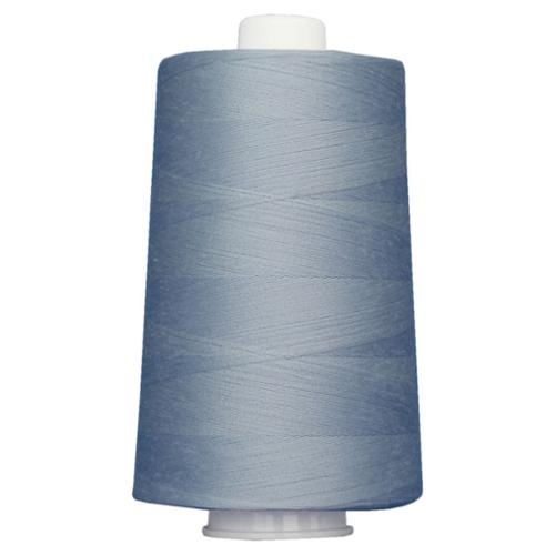 Large spool of blue thread on a white background