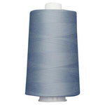 Large spool of blue thread on a white background