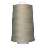 Spool of beige thread on a white background