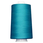 Large spool of teal thread on a white background