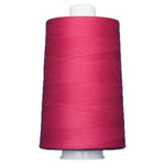 Spool of pink thread on a white background