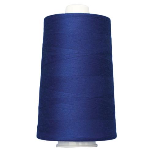 Spool of blue thread on a white background