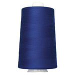 Spool of blue thread on a white background