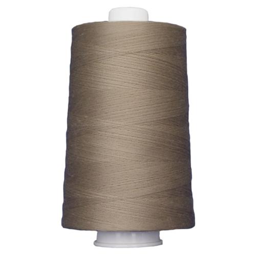 Spool of brown thread on a white background