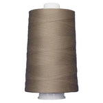 Spool of brown thread on a white background