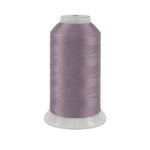 Spool of purple thread on a white background