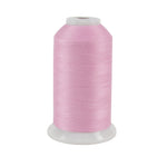 A spool of pink thread on a white background