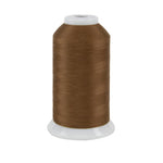 Brown spool of thread on a white background