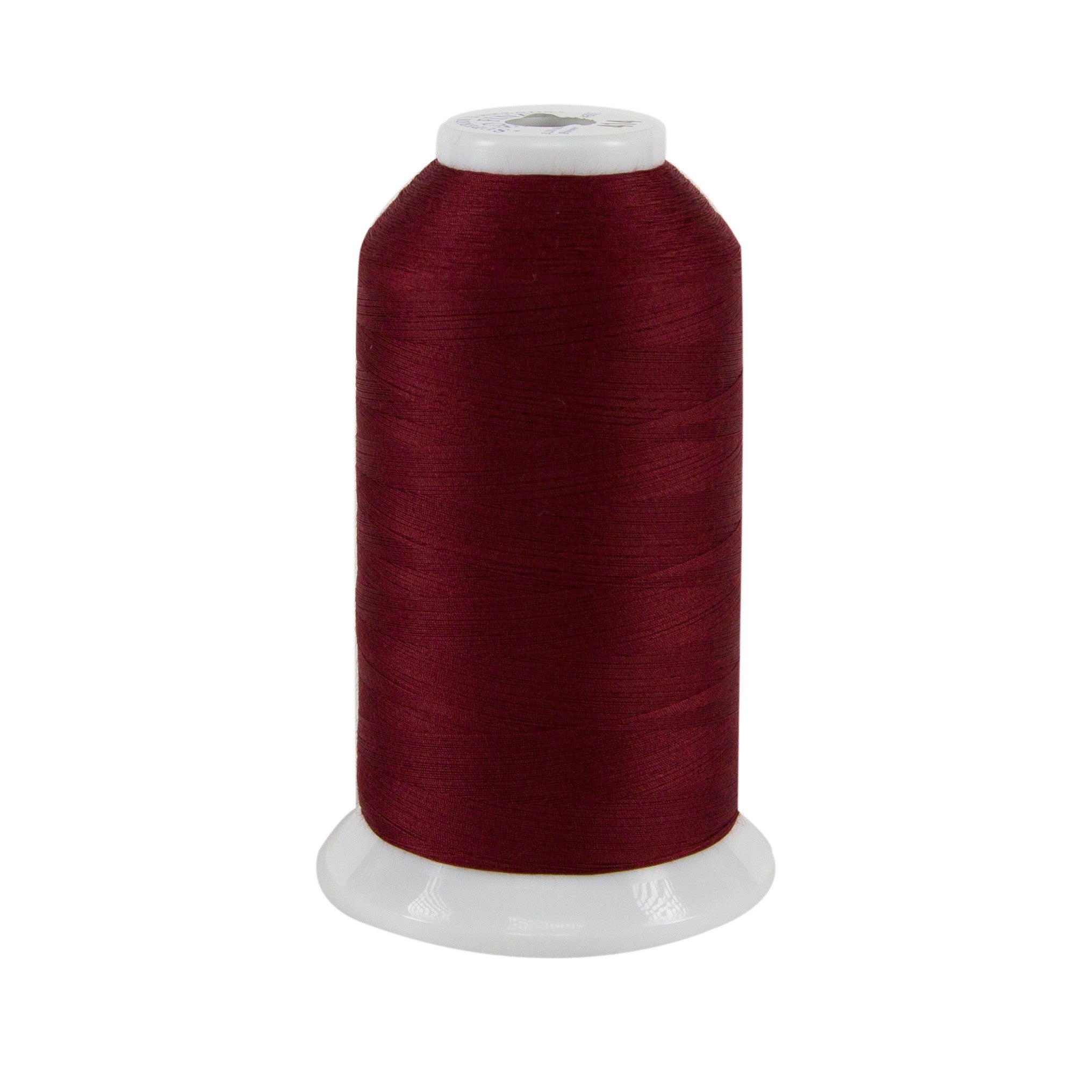 Spool of dark red thread on a white background