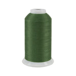 Spool of green thread on a white background