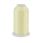 Spool of pale yellow thread on a white background