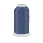Spool of blue thread on a white background