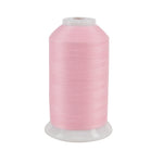 Spool of pink thread on a white background