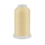 Spool of pale yellow thread on a white background