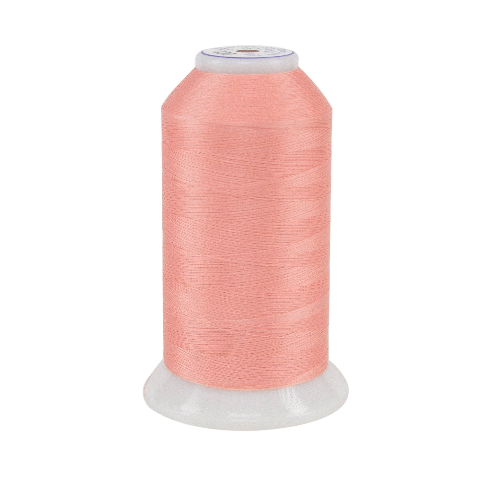 Spool of pink thread on a white background