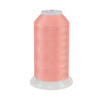 Spool of pink thread on a white background