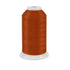 Spool of orange thread on a white background