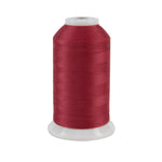 Spool of red thread on a white background